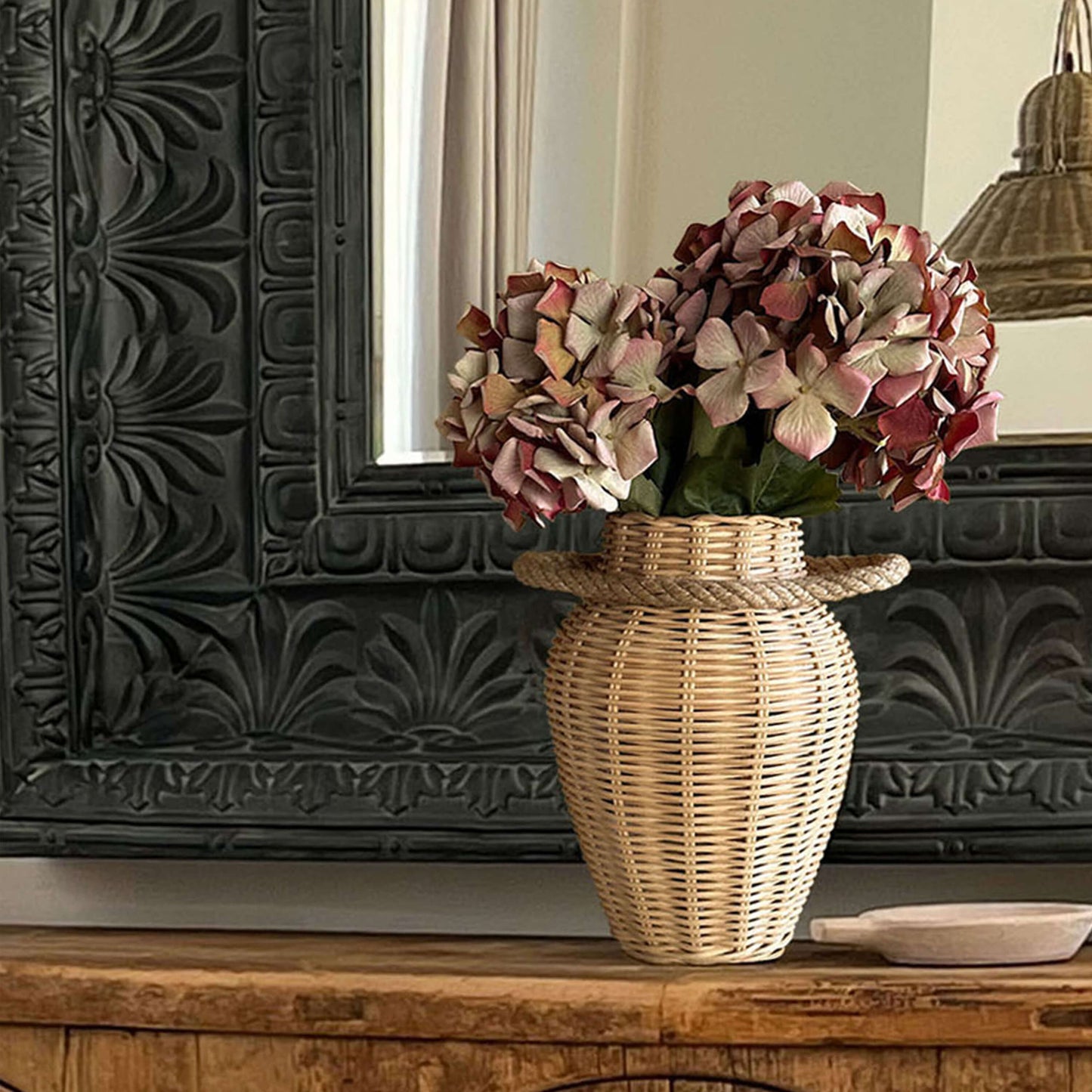 Boho ve İskandinav tarzda dekore edilmiş bir mekânda, el yapımı hasır ve rattan malzemeden üretilmiş, doğal dokulu büyük dekoratif vazo; sıcak ve estetik bir görünüm sunuyor